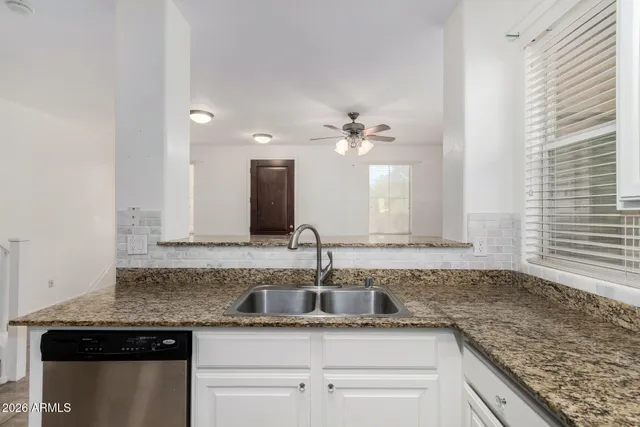 a kitchen with stainless steel appliances granite countertop a sink and cabinets