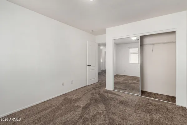 an empty room with closet area