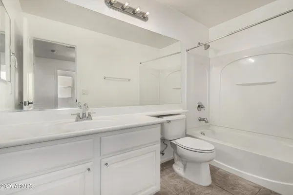 a bathroom with a sink toilet vanity and shower