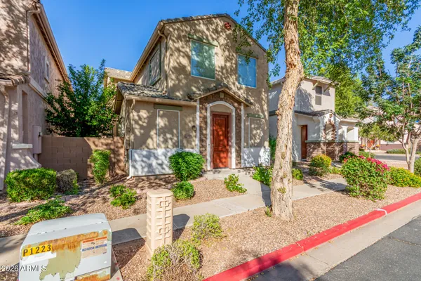 a front view of a multi story residential apartment building with yard