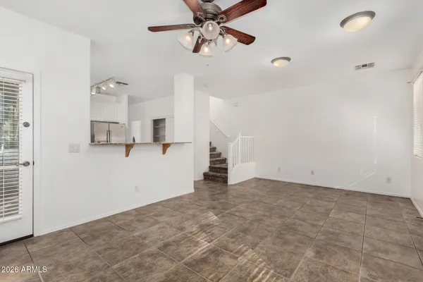 a view of a livingroom with a ceiling fan and window