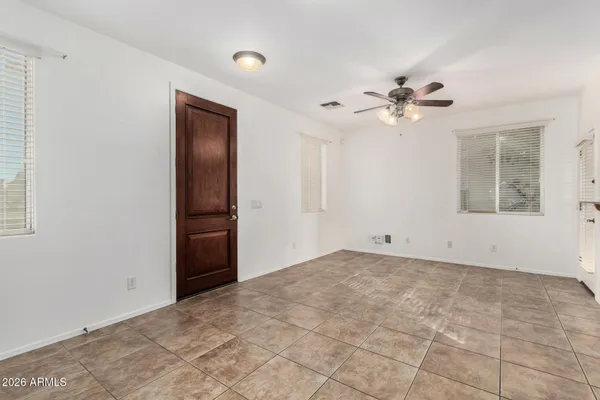 a view of empty room with a ceiling fan