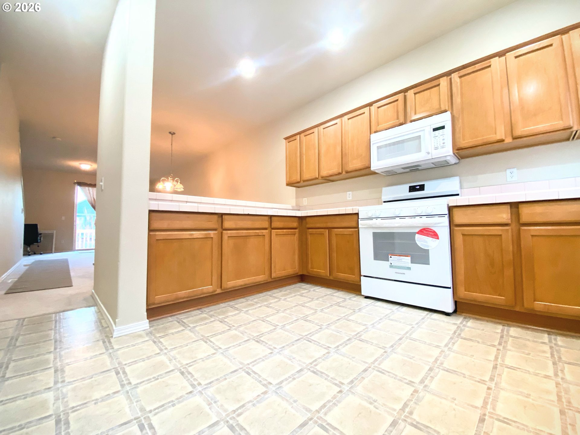 17446 Southwest October Court Beaverton, OR 97003 - Photo 16 of 21 a kitchen with stainless steel appliances granite countertop a sink and cabinets