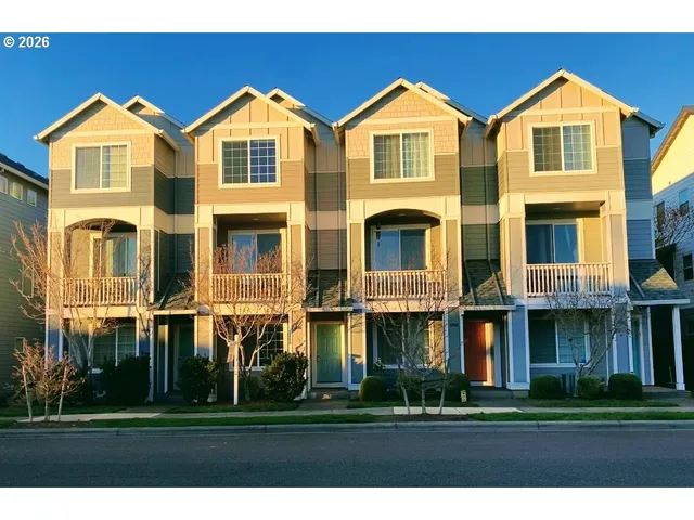 a city street with cars parked in front of it