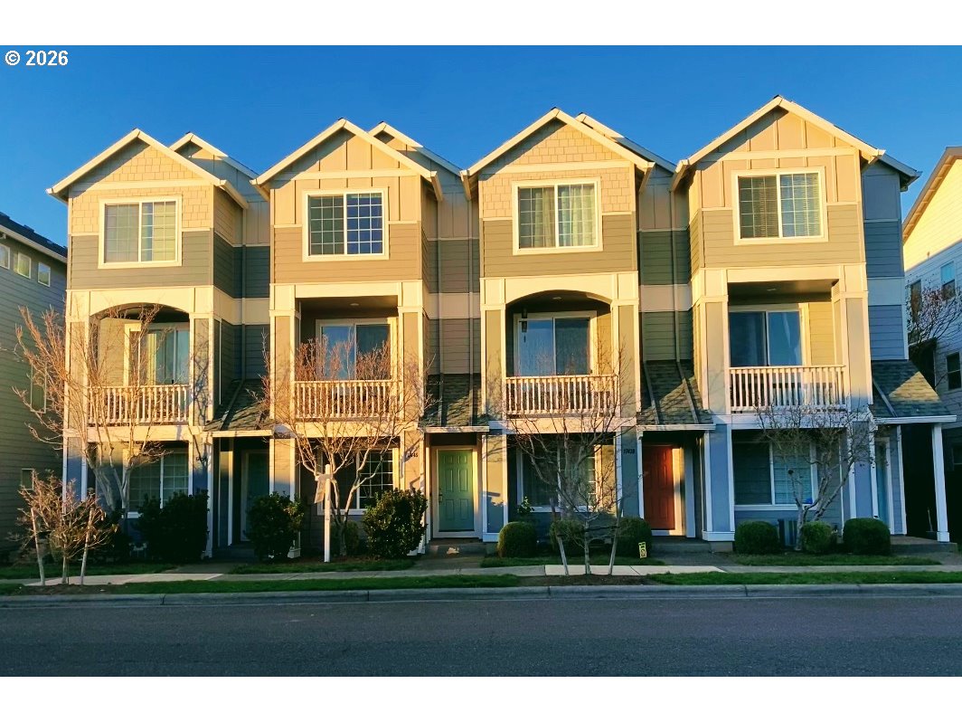 17446 Southwest October Court Beaverton, OR 97003 - Photo 18 of 21 a front view of a residential apartment building with a yard