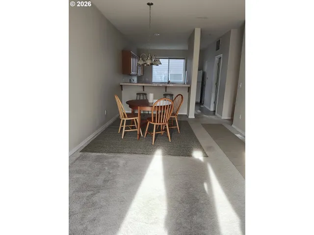 a view of a dining room with furniture and window