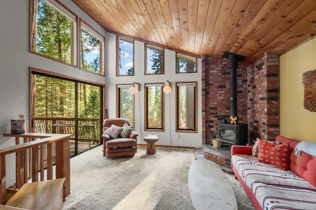 a living room with furniture and large windows