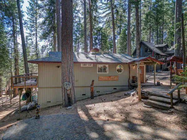 a view of a house with a yard and sitting area