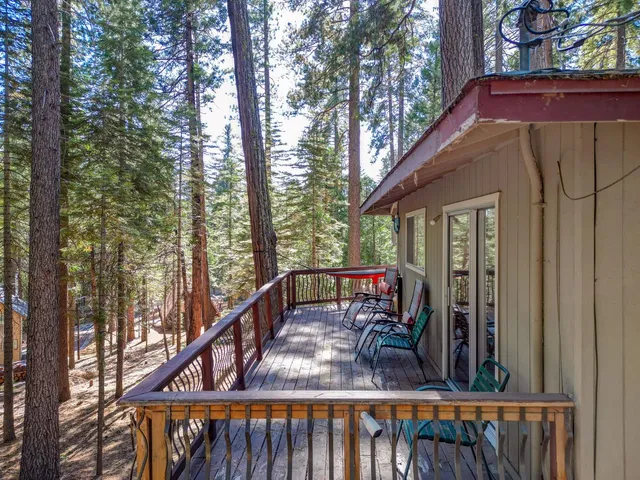 a view of a balcony with furniture and wooden deck