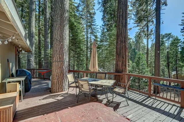 a view of a patio with a table chairs and backyard