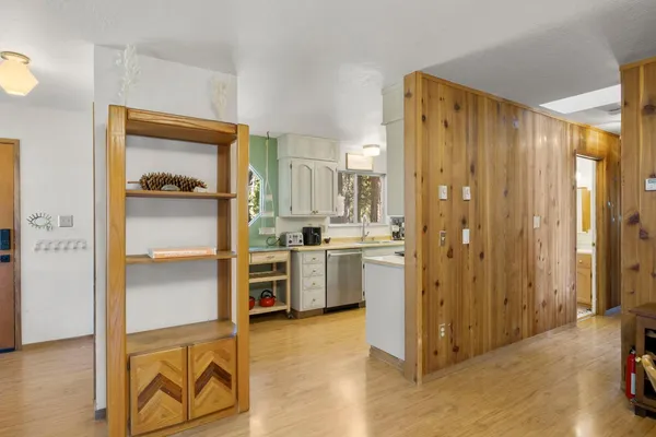 a view of a kitchen with a refrigerator a sink and dishwasher cabinets