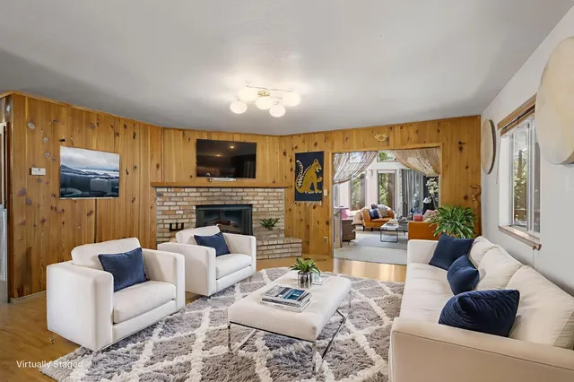 a living room with furniture fireplace and a flat screen tv