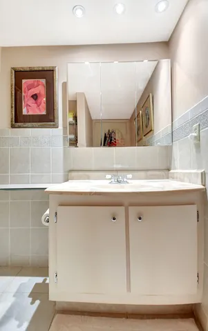 a view with granite countertop a sink and a mirror