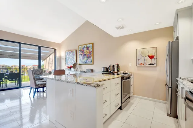 a kitchen with stainless steel appliances granite countertop a stove and a refrigerator