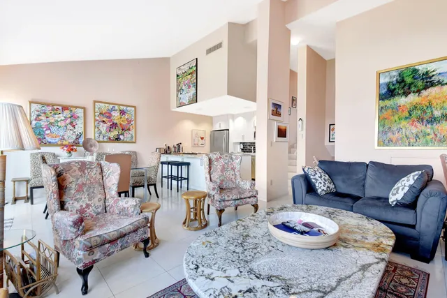 a living room with furniture and a floor to ceiling window