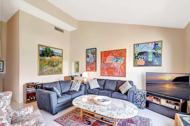 a living room with fireplace furniture and a window