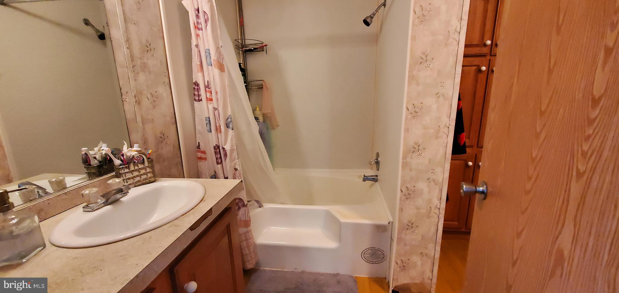 13 Springway Conowingo, MD 21918 - Photo 18 of 22 a bathroom with a sink a tub and a mirror