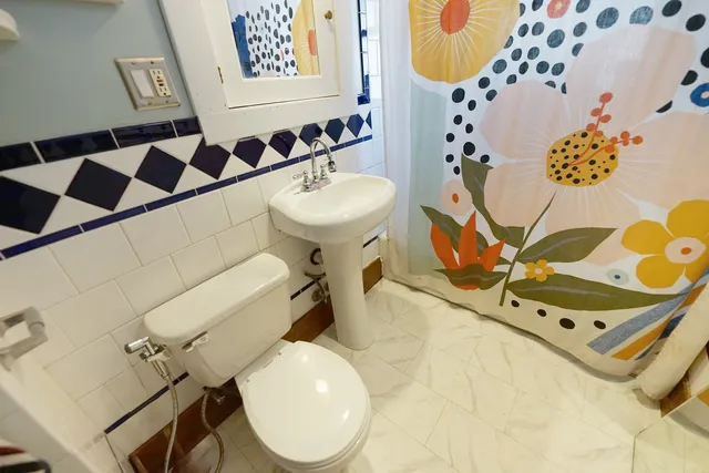a bathroom with a sink mirror vanity and toilet