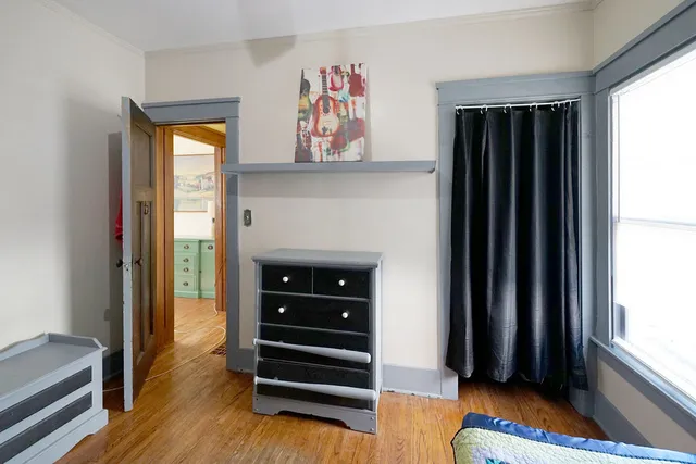 a view of bedroom with a bed and a window