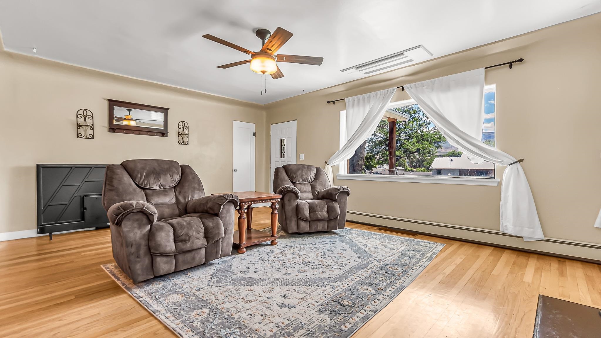 208 3rd Street Parachute, CO 81635 - Photo 3 of 40 a living room with furniture and a window