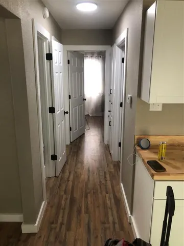 a kitchen with sink a refrigerator and cabinets