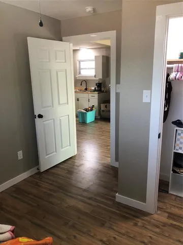a view of a kitchen with wooden floor