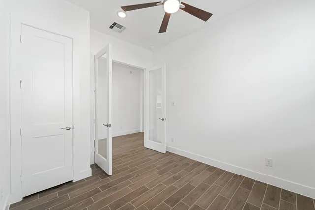 a view of a hallway with wooden floor