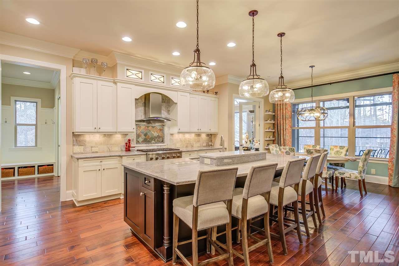 6037 Valencia Court Raleigh, NC 27614 - Photo 15 of 30 a large kitchen with a table and chairs