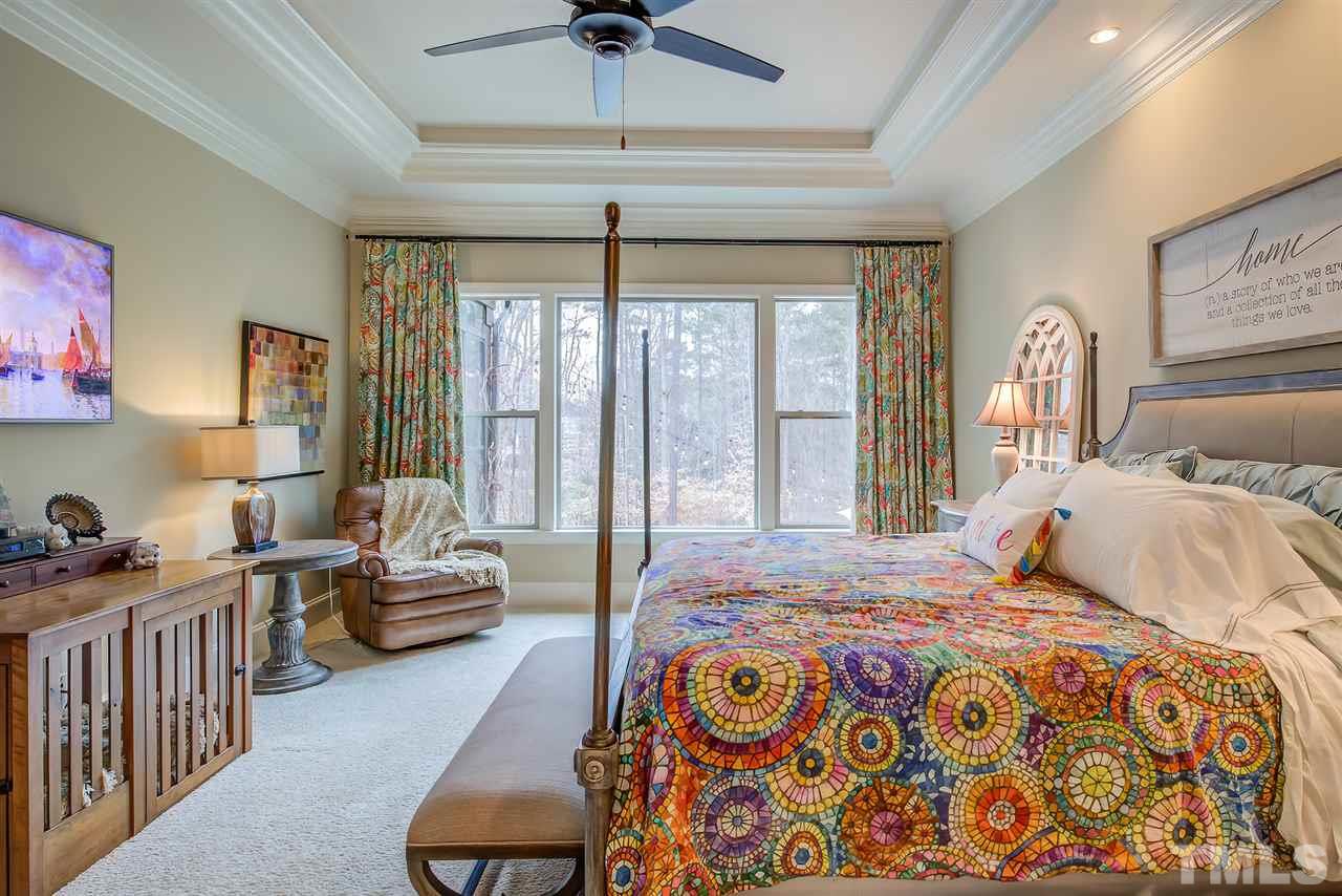 6037 Valencia Court Raleigh, NC 27614 - Photo 18 of 30 a bedroom with a bed and a chandelier