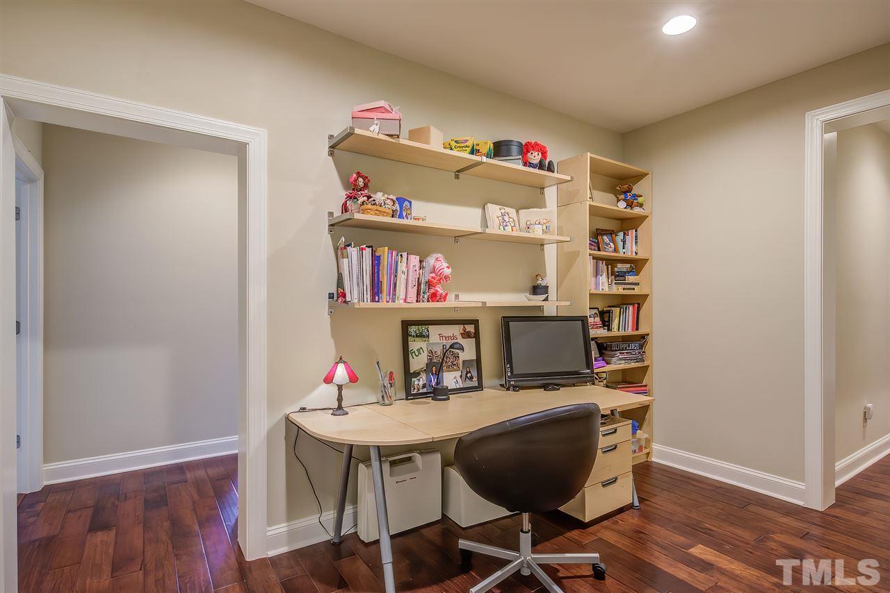 6037 Valencia Court Raleigh, NC 27614 - Photo 24 of 30 a room with furniture a rug and a wooden floor