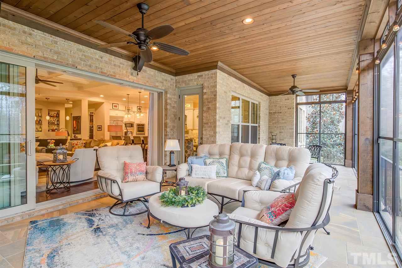 6037 Valencia Court Raleigh, NC 27614 - Photo 27 of 30 a living room with furniture and floor to ceiling windows
