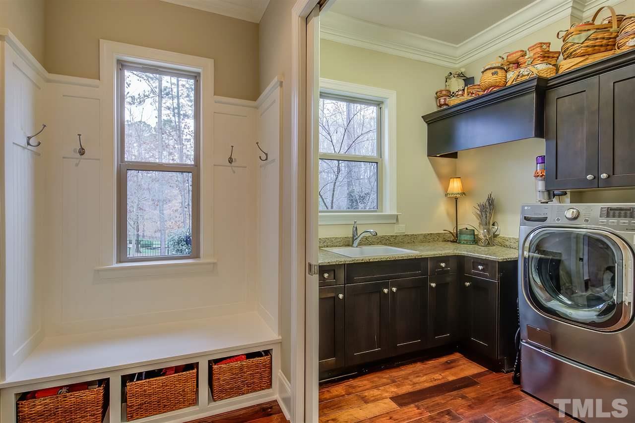 6037 Valencia Court Raleigh, NC 27614 - Photo 29 of 30 a view of a kitchen with a sink washer and dryer