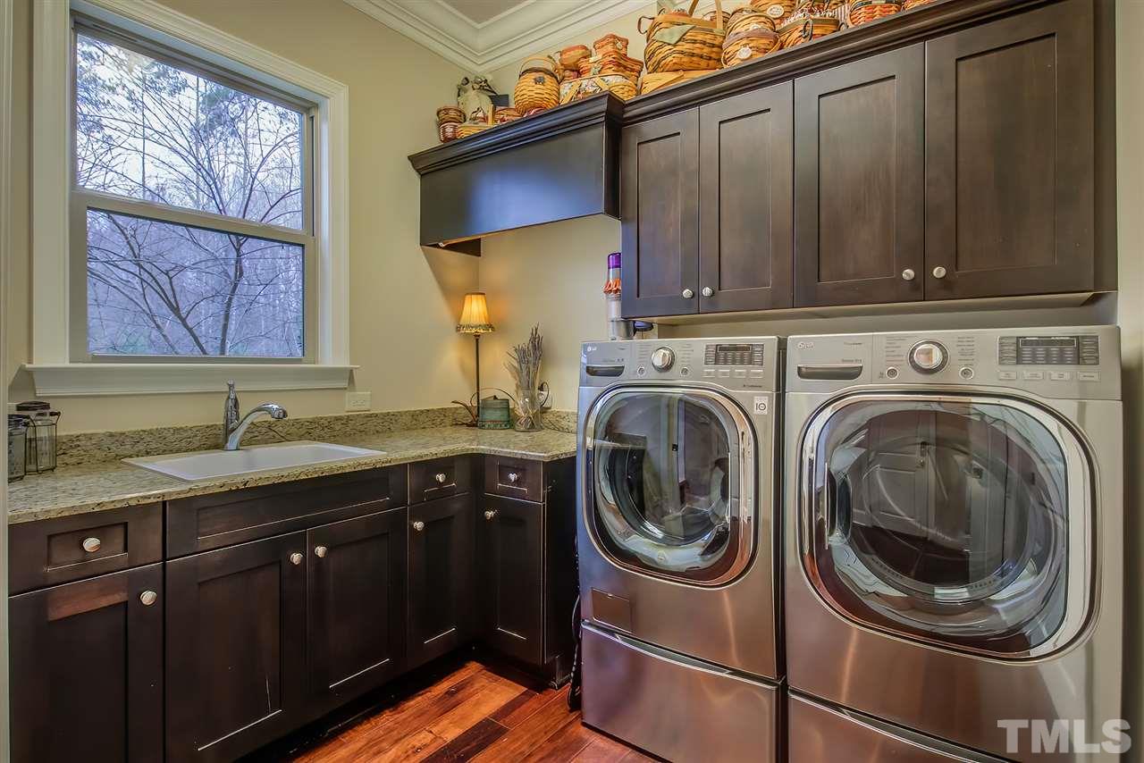 6037 Valencia Court Raleigh, NC 27614 - Photo 30 of 30 a utility room with sink dryer and washer