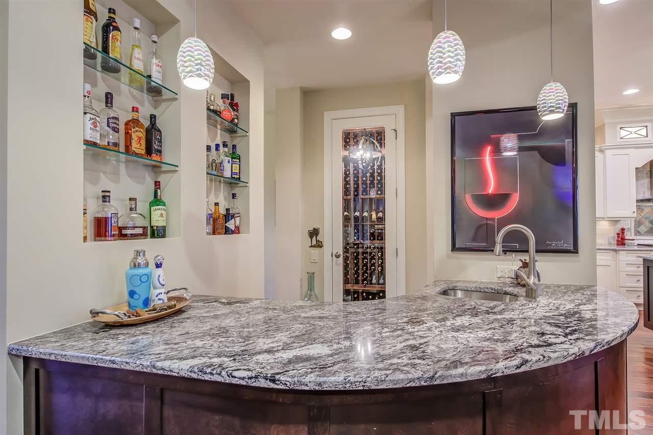 6037 Valencia Court Raleigh, NC 27614 - Photo 8 of 30 a room with kitchen island granite countertop stainless steel appliances and chandelier