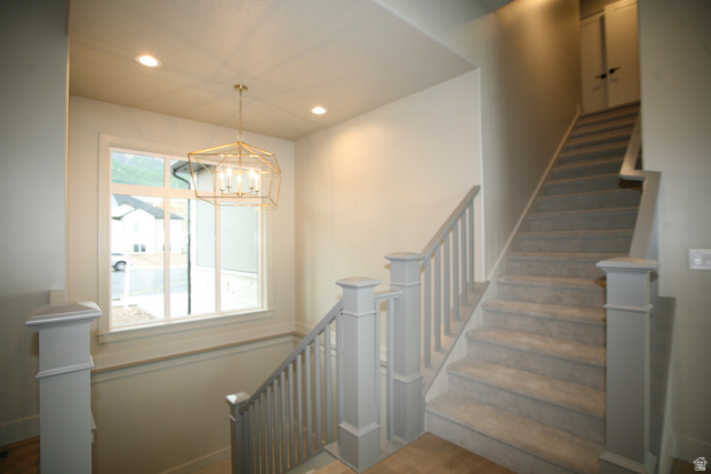 635 East Mountain Road North Ogden, UT 84414 - Photo 29 of 33 Staircase featuring carpeted treads, painted balusters, and square newel posts