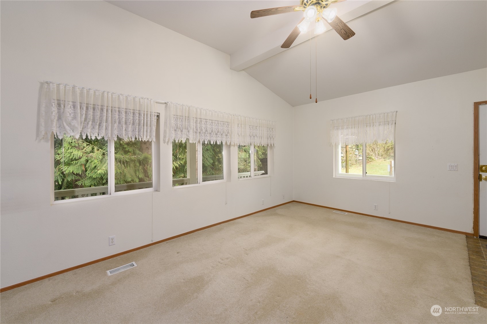 175 South Toutle Road Toutle, WA 98649 - Photo 5 of 29 an empty room with windows and chandelier fan
