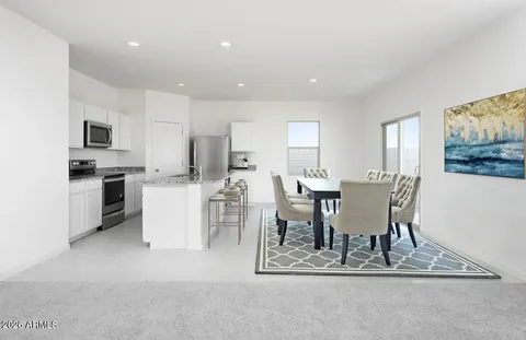a kitchen with stainless steel appliances granite countertop a refrigerator and a stove top oven