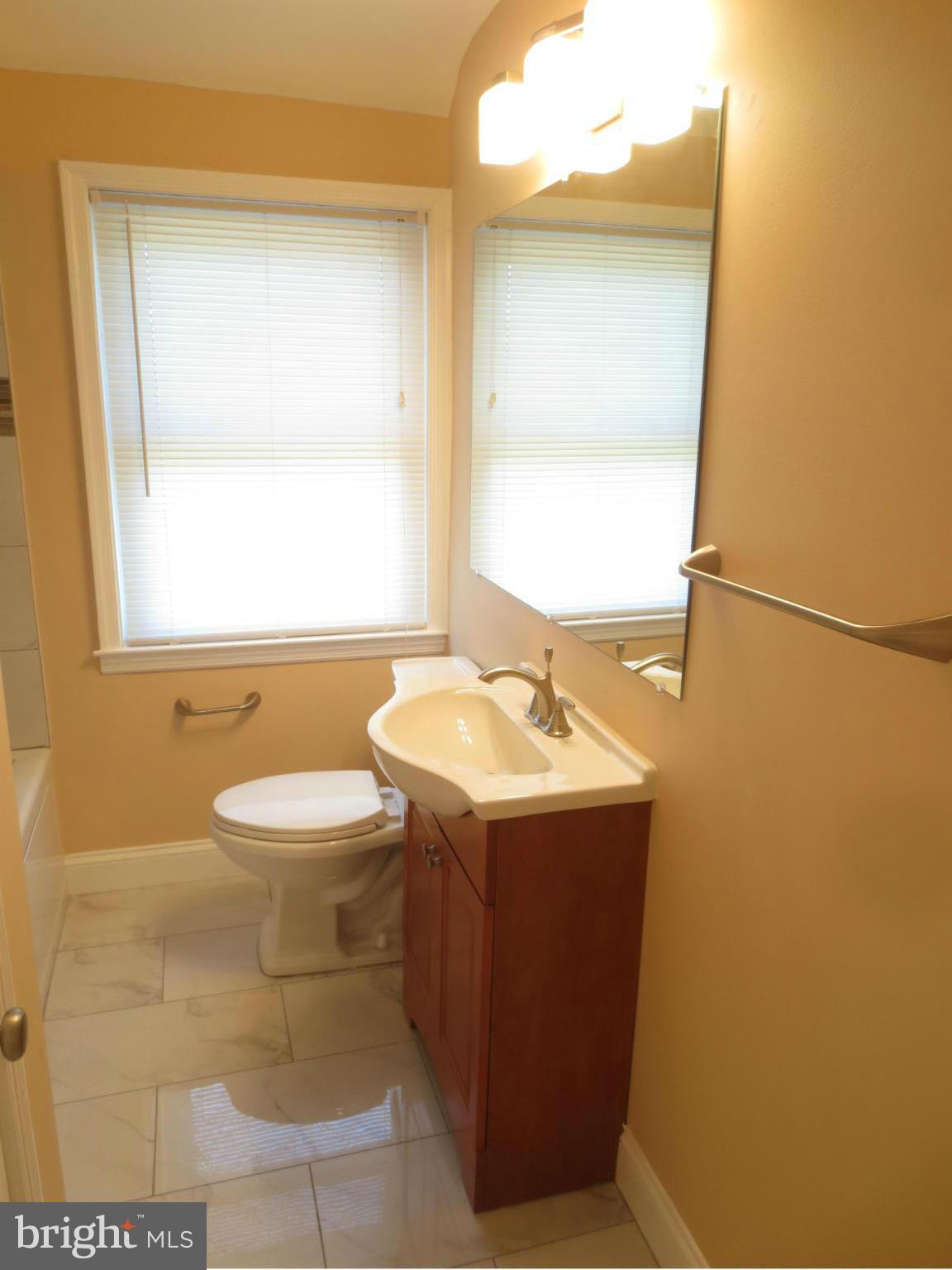 1405 Kitmore Road Baltimore, MD 21239 - Photo 14 of 25 a bathroom with a sink toilet and mirror