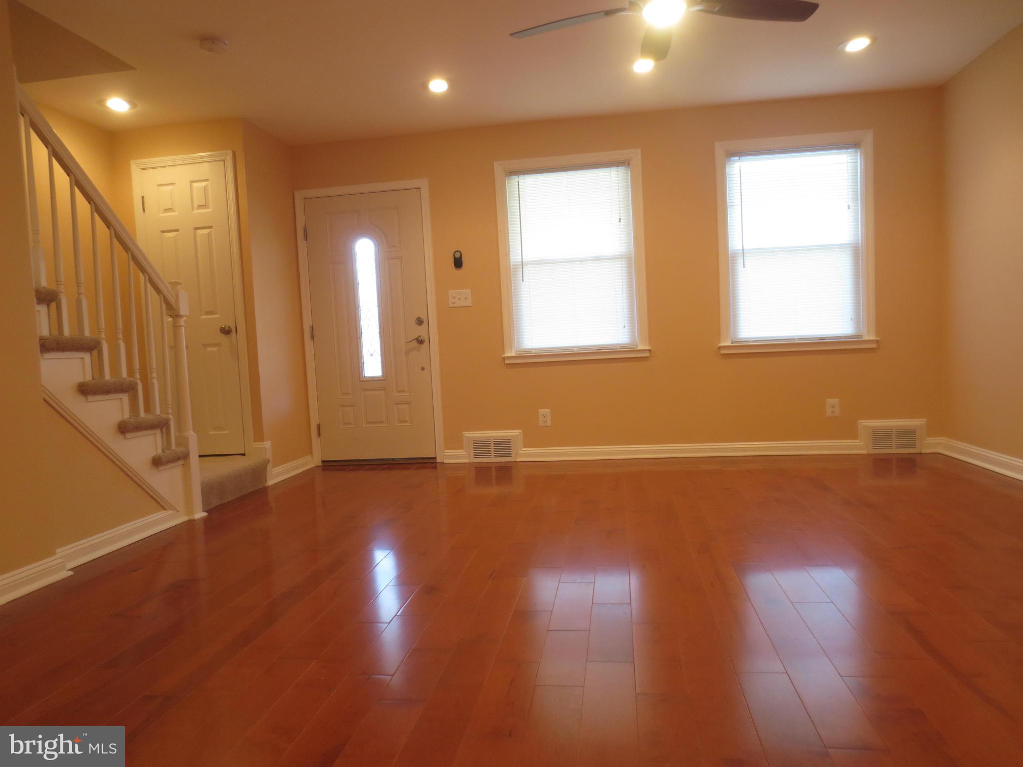 1405 Kitmore Road Baltimore, MD 21239 - Photo 9 of 25 a view of an empty room with wooden floor and a window
