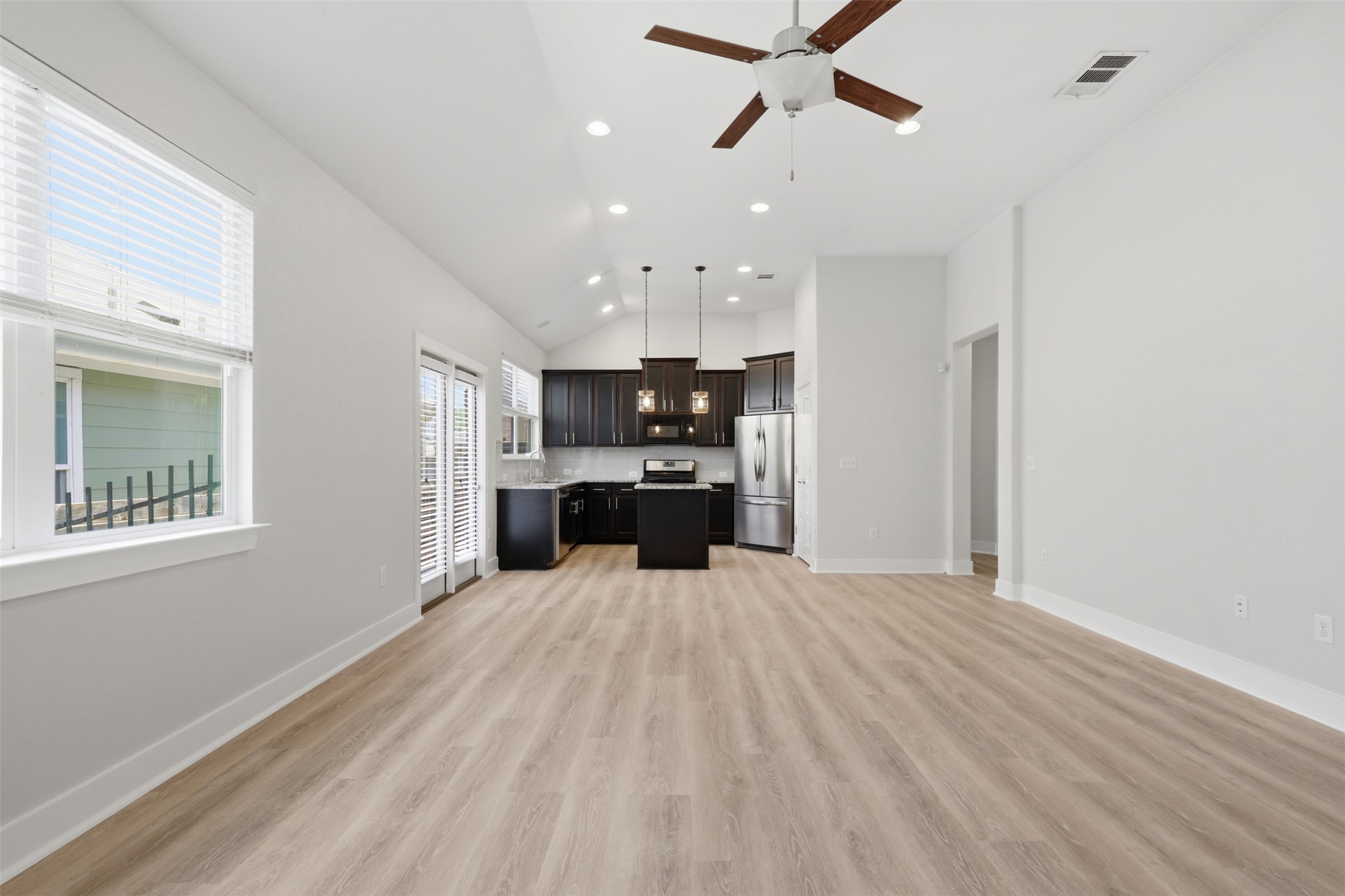 7208 Lysander Court Austin, TX 78741 - Photo 5 of 15 a large kitchen with kitchen island a sink stainless steel appliances and cabinets