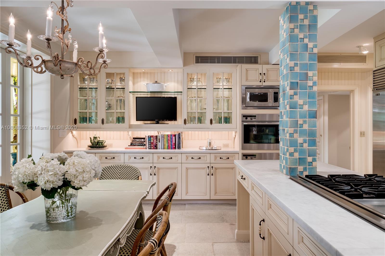 1030 Hardee Road Coral Gables, FL 33146 - Photo 11 of 55 a kitchen with stainless steel appliances a stove a sink dishwasher a refrigerator white cabinets a dining table and chairs with wooden floor