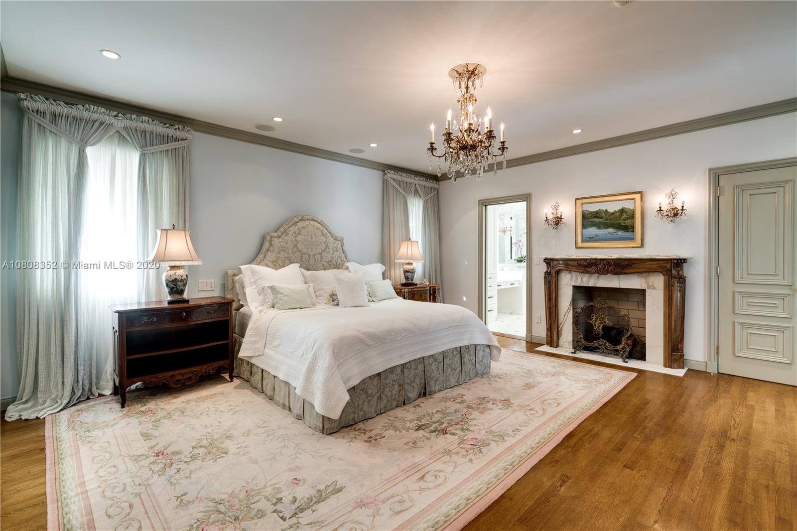 1030 Hardee Road Coral Gables, FL 33146 - Photo 20 of 55 a spacious bedroom with a bed and a fireplace