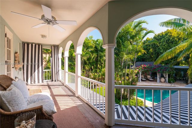 a front view of a building with a garden and sitting area
