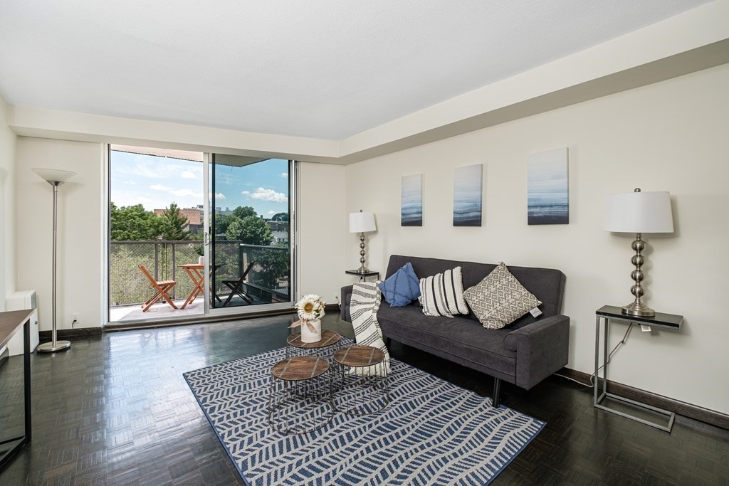 19 Winchester Street, Unit 801 Brookline, MA 02446 - Photo 3 of 19 a living room with furniture and a window