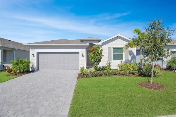 a front view of a house with a yard and garage
