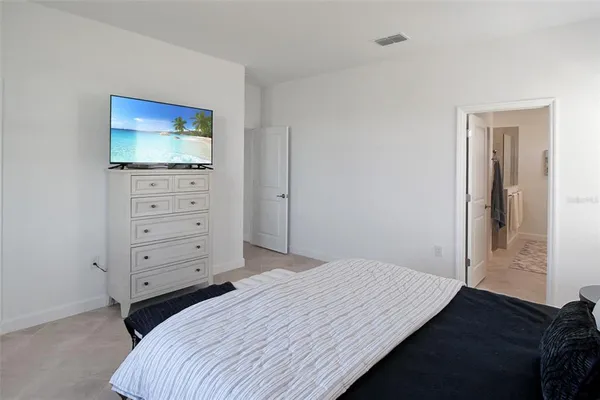 a spacious bathroom with double vanity and a mirror