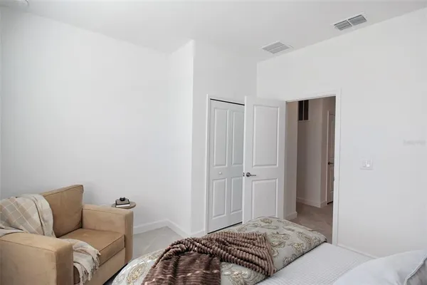 a view of a hallway with bathroom and a closet