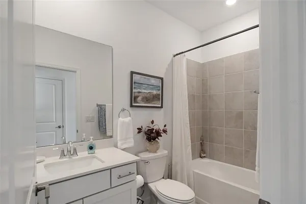 a bathroom with a bathtub a shower and a sink