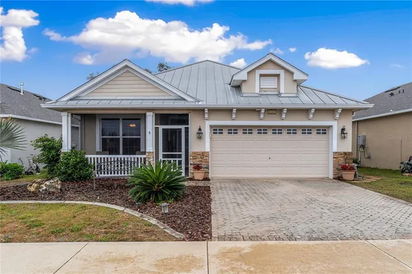 a view of a house with a yard and garage