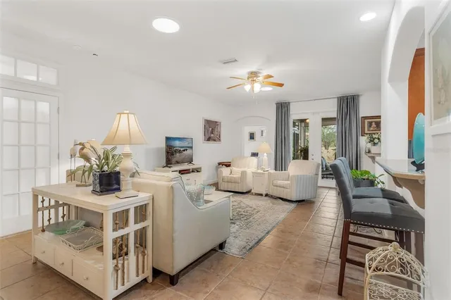 a living room with furniture and a chandelier